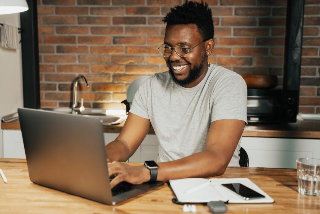Affiliate promoting a brand to his online audience from his laptop