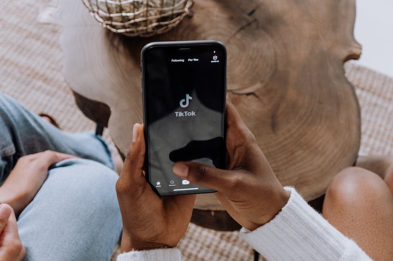 Woman using TikTok for an influencer marketing campaign on her phone